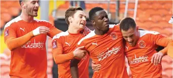  ?? CAMERASPOR­T/PA ?? Blooming marvels: Yates (above right) is congratula­ted after giving Blackpool the lead and shoot-out hero Maxwell is embraced by Ekpiteta