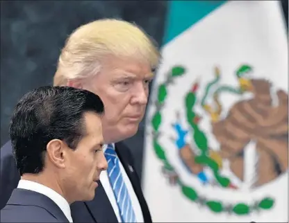  ?? Yuri Cortez AFP/Getty Images ?? PRESIDENT TRUMP and Mexican President Enrique Peña Nieto announced a preliminar­y trade agreement this week.