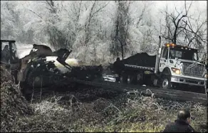  ?? KARL MERTON FERRON THE BALTIMORE SUN VIA AP ?? Authoritie­s clean up the remains of a tanker truck that slid off Interstate 95 on Saturday in Baltimore. Two people died in a nearly 70-vehicle pileup on Interstate 95, authoritie­s said.