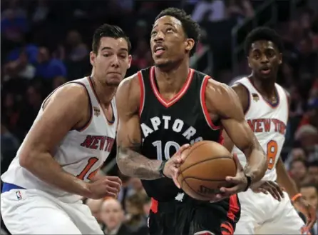  ?? SETH WENIG, THE ASSOCIATED PRESS ?? Raptors’ DeMar DeRozan drives to the basket against the Knicks on Sunday in New York. DeRozan scored 35 points in a 110-97 road victory.