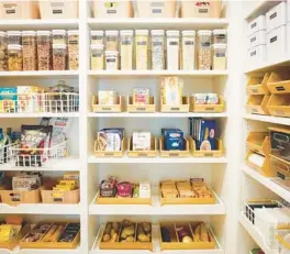  ?? MDESIGN ?? Labels, bins and baskets impose order on this home’s pantry, making cooking and putting food away faster and more efficient. But before a pantry can look this good, home chefs need to clean out old, unwanted and expired food.