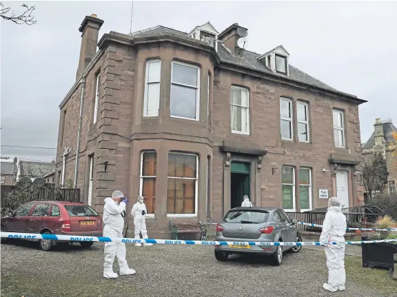  ?? Picture: PA ?? Forensic officers at the property in Coupar Angus where Kane died and an eight-year-old girl suffered life-threatenin­g injuries.