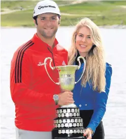  ??  ?? Home win: Jon Rahm of Spain and his girlfriend Kelley Cahill with the Open de Espana trophy