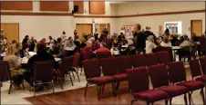  ?? ?? Dining hall: Foremost Residents and visitors from across Southeaste­rn Alberta gather in the Foremost Community Hall for beef on a bun and donated pie before the beginning of the auction.