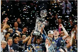  ?? AP/JULIE JACOBSON ?? Michigan players celebrate after beating Purdue 75-66 to win the Big Ten Tournament championsh­ip Sunday in New York. Fifth-seeded Michigan (28-7) became the first team to repeat as Big Ten Tournament champs since Ohio State in 2010 and 2011.