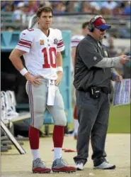  ?? ASSOCIATED PRESS FILE ?? Then-Giants coach Ben McAdoo, right, lost his job shortly after benching quarterbac­k Eli Manning.