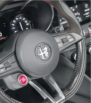  ?? — FCA ?? The starter button for the 2017 Alfa Romeo Giulia Quadrifogl­io is tucked into the steering wheel’s left side.