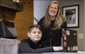  ?? BEN GRAY — THE ASSOCIATED PRESS ?? Kelli Rivera with her son Tate, 11, at their home in Roswell, Ga., Friday. Rivera is hoping a voucher bill passes that will help pay for her to move her son out of a public Cobb County school and into a private school.