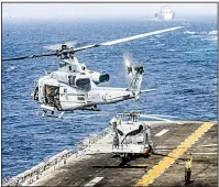  ?? The New York Times/U.S. Marine Corps/LANCE CPL. DALTON SWANBECK ?? A helicopter takes off Thursday from the flight deck of the USS Boxer, the amphibious assault ship that officials said took out an Iranian drone in the Strait of Hormuz as it flew too close to the ship.