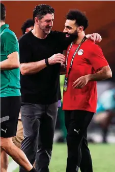  ?? — AFP photo ?? Egypt’s forward Salah (right) speaks with head coach Rui Vitoria during the Africa Cup of Nations (CAN) 2024 group B match between Cape Verde and Egypt at the Felix Houphouet-Boigny Stadium in Abidjan.