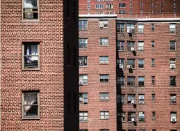  ?? DREW ANGERER/GETTY 2018 ?? The Alfred E. Smith Houses, a public housing developmen­t built and maintained by the New York City Housing Authority, stand in the Lower East Side of Manhattan.