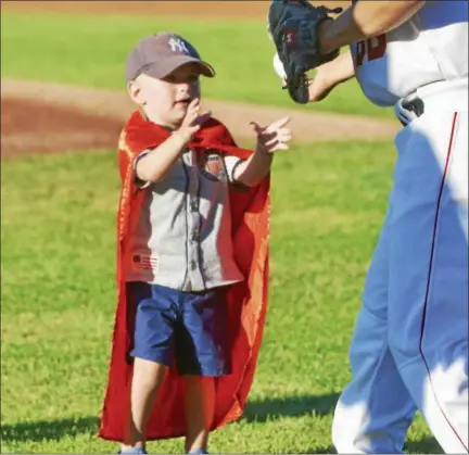  ?? PHOTO BY JOE BOYLE ?? Connor Daddario accepts his ball from the catcher after his ceremonial first pitch