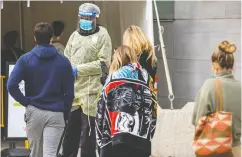  ?? CARLOS OSORIO / REUTERS ?? People wait in line at the Women’s College coronaviru­s disease testing facility in Toronto.
