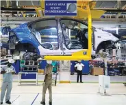  ??  ?? REUTERS Workers assemble a Tata Tigor car inside the Tata Motors car plant in Sanand, on the outskirts of Ahmedabad, India.