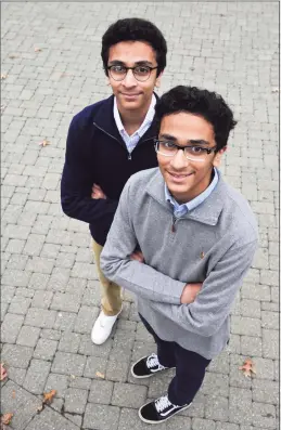  ?? H John Voorhees III / Hearst Connecticu­t Media ?? Danbury High School seniors Adam Bhavnagarw­ala, right, and his twin brother, Ibrahim, have created a prototype for an invention that can detect toxic gases at extremely low concentrat­ions and sooner than smoke detectors.