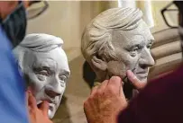  ??  ?? Artist Chas Fagan, left, fine-tunes his sculpture of Wiesel.