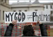  ?? ASSOCIATED PRESS FILE PHOTO ?? A woman holds a sign during a protest at the state house in Trenton, N.J.