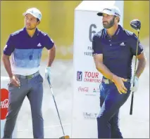  ?? Curtis Compton The Associated Press ?? Dustin Johnson, right, watches after teeing off on No. 6. Johnson won the Tour Championsh­ip, with Xander Schauffele, left, and Justin Thomas, not pictured, sharing second place.