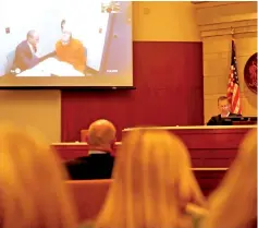  ??  ?? People watch from the courtroom as Patterson appears via live video from jail, wearing an orange jumpsuit, during his first court appearance in Barron, Wisconsin. — Reuters photo