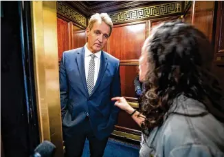  ?? JIM LO SCALZO / EPA-EFE / REX / SHUTTERSTO­CK ?? A protester confronts U.S. Sen. Jeff Flake, R-Ariz., on Friday at the Russell Senate Office Building in Washington after he announced he would vote to confirm Brett Kavanaugh to the U.S. Supreme Court. “You are telling me that my assault doesn’t matter,” she said.