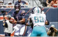 ?? NAM Y. HUH — THE ASSOCIATED PRESS ?? Bears quarterbac­k Justin Fields looks to pass against the Dolphins on Aug. 14 in Chicago.