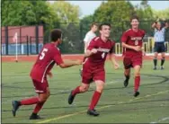  ?? MICHAEL REEVES — FOR DIGITAL FIRST MEDIA ?? West Chester Henderson’s Charlie Collins (4) celebrates his game-winning goal with teammates KJ Walkes (5) and Kevin Kiefer (9).