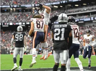  ?? DAVID BECKER/AP ?? Tight end Jesper Horsted celebrates his two-yard touchdown catch with Cole Kmet.