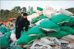 ?? LIN HAO / CHINA NEWS SERVICE ?? Plastic waste seized in January from two trucks is inspected by customs officers in Dongxing, Guangxi Zhuang autonomous region.