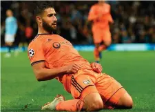  ??  ?? Nabil Fekir slides in celebratio­n after scoring Lyon’s second goal during their shock victory against Manchester City