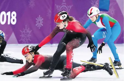  ?? NATHAN DENETTE/THE CANADIAN PRESS ?? Canada’s Valerie Maltais tumbles as teammate Kim Boutin tries to help her during the controvers­ial women’s 3,000-metre short-track speedskati­ng relay final. Canada’s disqualifi­cation was possibly due to an unintentio­nal infraction at the finish line.
