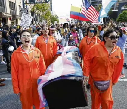  ?? SANTIAGO MEJIA/SAN FRANCISCO CHRONICLE VIA AP ?? In June, participan­ts in San Francisco’s annual Trans March carried a memorial to transgende­r lives lost.