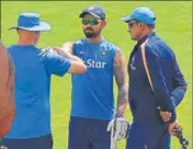 ?? PTI ?? India team physio Patrick Farhart tests Virat Kohli’s heavily strapped right shoulder as coach Anil Kumble looks on, in Dharamsala on Thursday. The skipper did not bat at the nets with the team saying it was a precaution­ary step.
