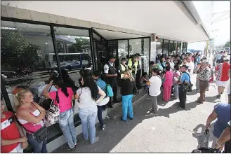  ??  ?? People queue up outside a bank in San Cristobal in an attempt to deposit money on Dec 13. Venezuelan President Nicolas Maduro ordered on Dec 12 the border with Colombia sealed for 72 hours, accusing US-backed ‘mafias’ of conspiring to destabiliz­e his...