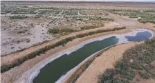  ?? AP ?? A canal affected by high salinity in the Siba area near Basra, where thousands are ill after drinking contaminat­ed water