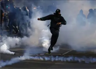  ?? FRANCOIS MORI, THE ASSOCIATED PRESS ?? Tear gas is used at a protest against President Emmanuel Macron’s labour policies in Paris on Thursday.