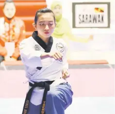  ??  ?? Nurul Hidayah Abdul Karim competes in the mixed pair poomsae with Augustine Rudy Grocer (unseen) at the Sarawak Sukma 2016.