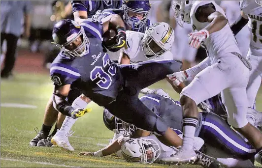  ?? Dan Watson/The Signal (See additional photos at signalscv.com) ?? Valencia’s Luring Paialii takes the ball toward the end zone in the second quarter against Calabasas High at Valencia High on Friday. The Vikings lost 21-20.