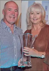  ??  ?? Liz Collard receives her Community Support Award from Joe Healy.