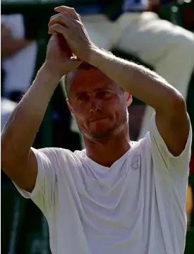  ?? AP ?? LLEYTONHew­itt of Australia acknowledg­es the crowd after playing his last match at Wimbledon, which he won in 2002. Jarkko Nieminen of Finland ousted Hewitt, 3-6, 6-3, 4-6, 6-0, 11-9, Monday. The 34-yearold Hewitt will retire after next year’s...