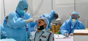  ??  ?? Medical staff taking a swab sample from a man at Dr Ram Manohar Lohia (RML) Hospital in New Delhi on July 31, 2020.