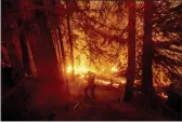  ?? NOAH BERGER — THE ASSOCIATED PRESS FILE ?? A firefighte­r battles the Creek Fire in the Shaver Lake community of Fresno County.