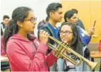  ??  ?? Playing the trumpet in the library? Yup, in a music session at the Santa Clara City Library — part of the expanded programs offered at public libraries. At this year's Chinese New Year celebratio­n, center, traditiona­l lion dancers made their way...