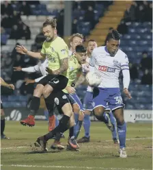  ??  ?? Danny Lloyd challenges for the ball with Neil Danns of Bury.