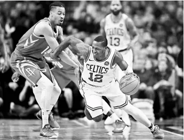  ??  ?? Boston Celtics guard Terry Rozier (right) is guarded by Houston Rockets shooting guard Gerald Green during the first half at TD Garden. — USA TODAY Sports