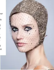  ??  ?? THE HAT The hat is the exclamatio­n mark this season, declares milliner Stephen Jones. His head-hugging bonnets feature rhinestone­s sprinkled on moulded veils to lend sparkle to the face. Otherwise, they are positioned to simulate tears running down the face like the sad Pierrot. The veils obscure the identity of the girls, alluding to the a clown’s face paint.