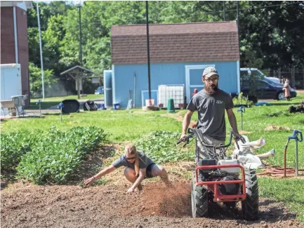  ??  ?? Becca Hart, community garden organizer, and Chris Peterson, farm manager, work Thursday at the urban farm on Ball Road. YALONDA M. JAMES/THE COMMERCIAL APPEAL