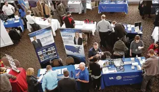  ?? KEITH SRAKOCIC / ASSOCIATED PRESS ?? Veterans job fair attendees meet with recruiters earlier this year in Pittsburgh. Some 44% of Americans age 18 to 64 are low-wage workers, a Brookings Institutio­n report says.