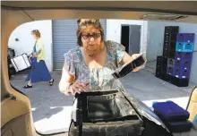  ??  ?? Meals on Wheels volunteer Denise Sandoval prepares one of her 12 deliveries.