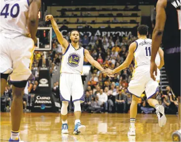  ?? CHRISTIAN PETERSEN/GETTY IMAGES ?? Stephen Curry (30) and Klay Thompson slap hands after Curry hit one of the Warriors’ NBA record 15 3-pointers in the first half.