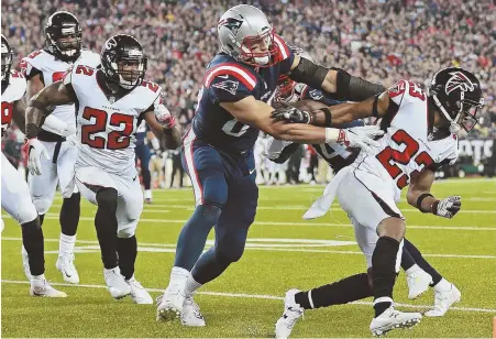  ?? STAFF PHOTO BY MATT WEST ?? PAVING THE ROAD: Rob Gronkowski tosses Falcons cornerback Robert Alford out of the way as receiver Brandin Cooks follows him into the end zone for a second-quarter touchdown.